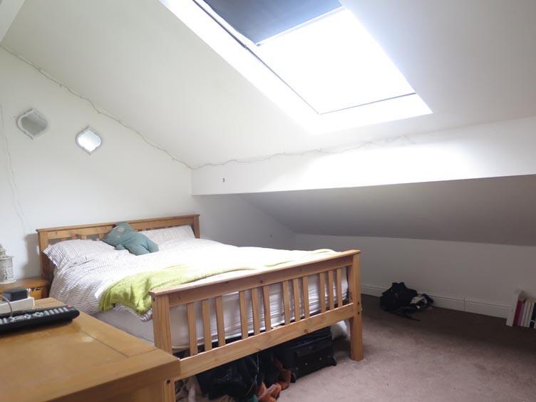 A cozy bedroom with a comfortable double bed an...