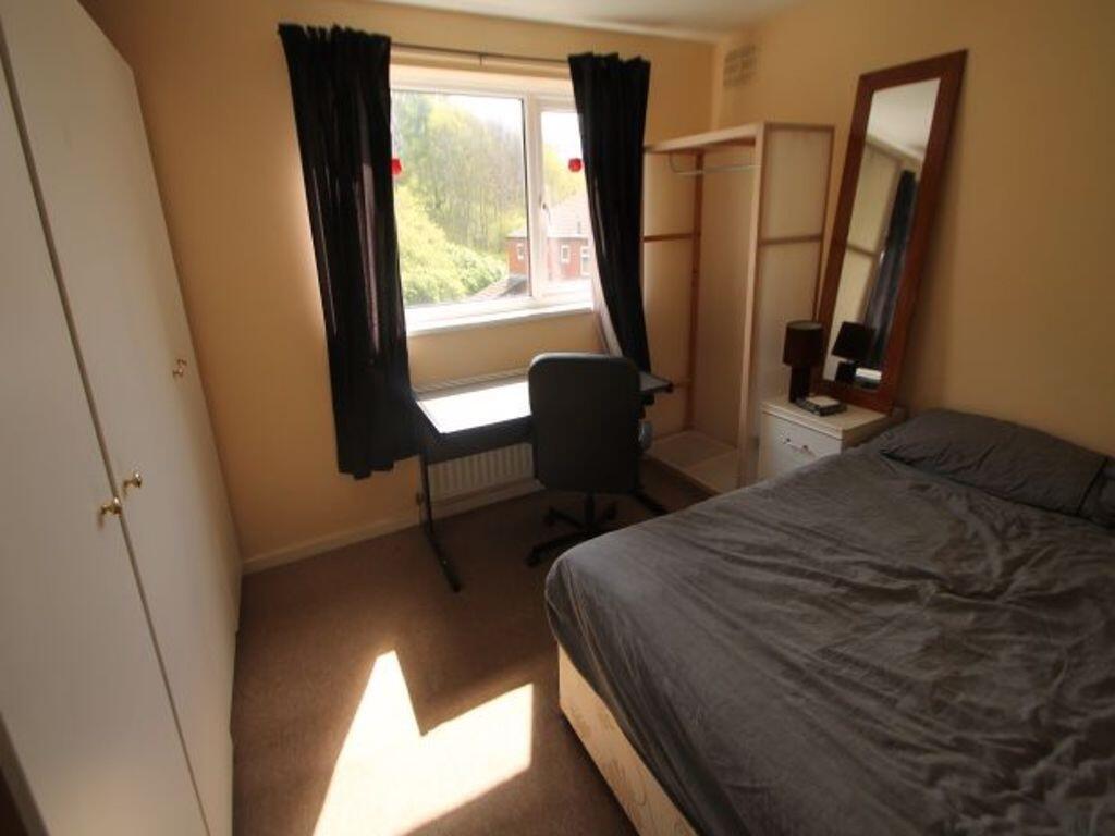 A cozy double bedroom featuring a comfortable d...