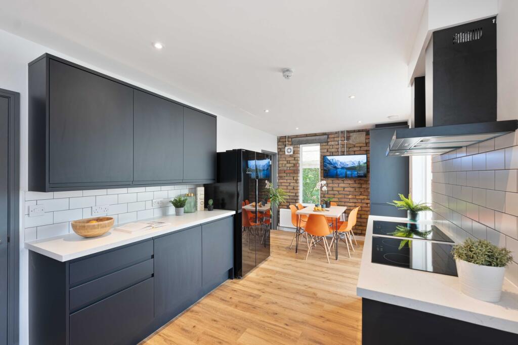 A modern and inviting kitchen with stylish blac...