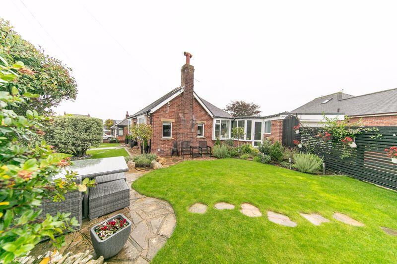 Neatly landscaped gardens surround