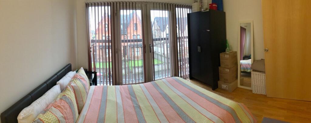 A bright and cozy double bedroom featuring a la...