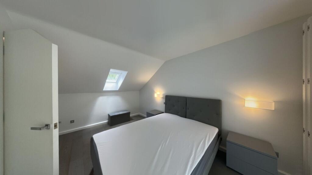 A bright and modern double bedroom featuring a ...