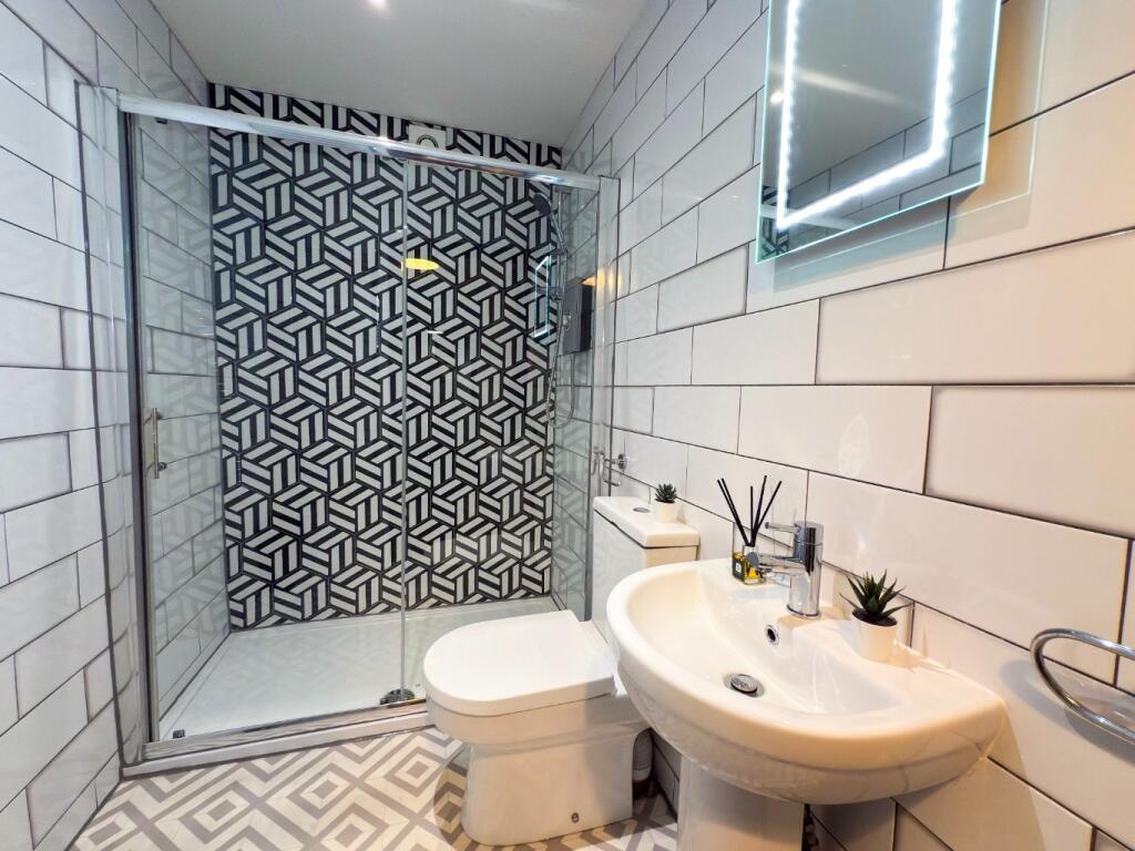 Modern and clean bathroom with a spacious showe...