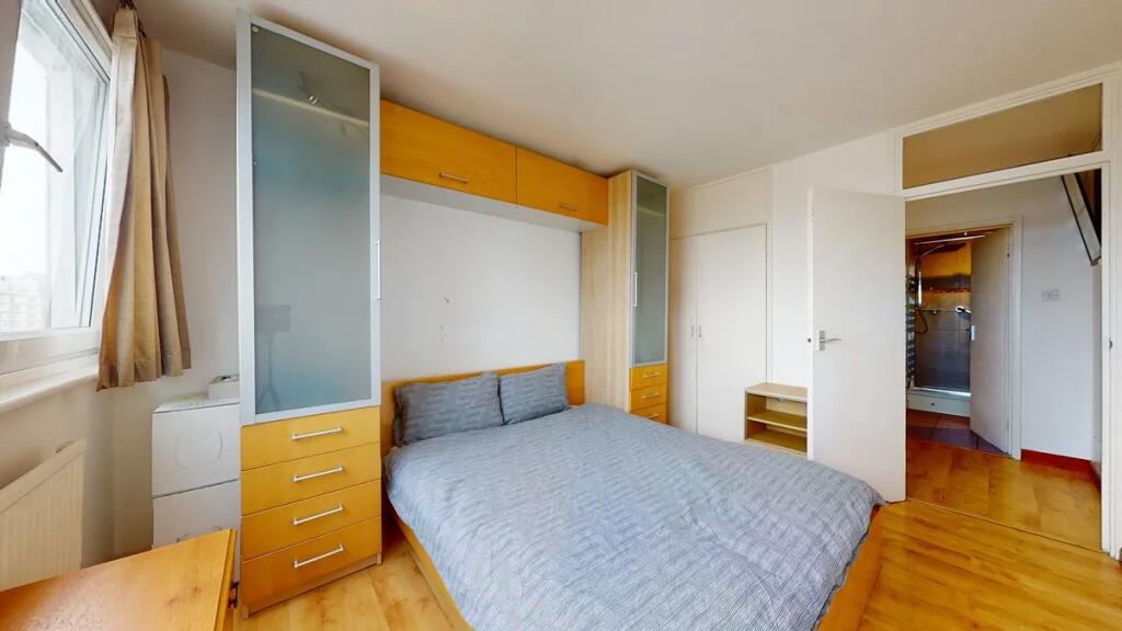 Bright and tidy double bedroom featuring a comf...