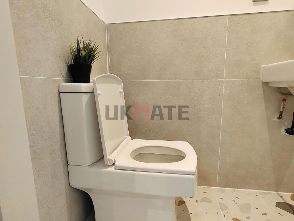 A clean and modern bathroom featuring a toilet ...