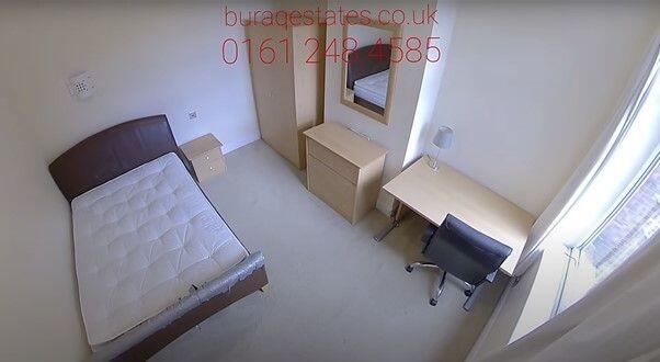 A bright single bedroom featuring a comfortable...