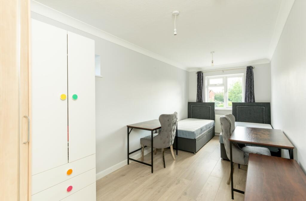 A bright and spacious double bedroom featuring ...