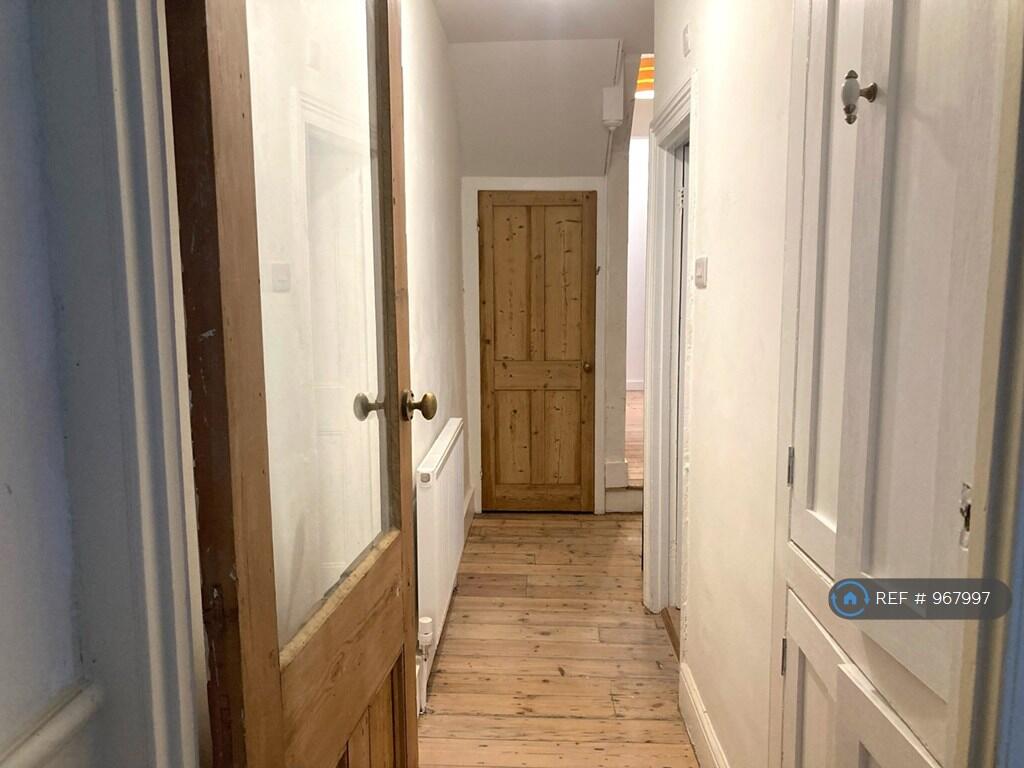 Hallway With Original Flooring &amp; Built In Cabinets