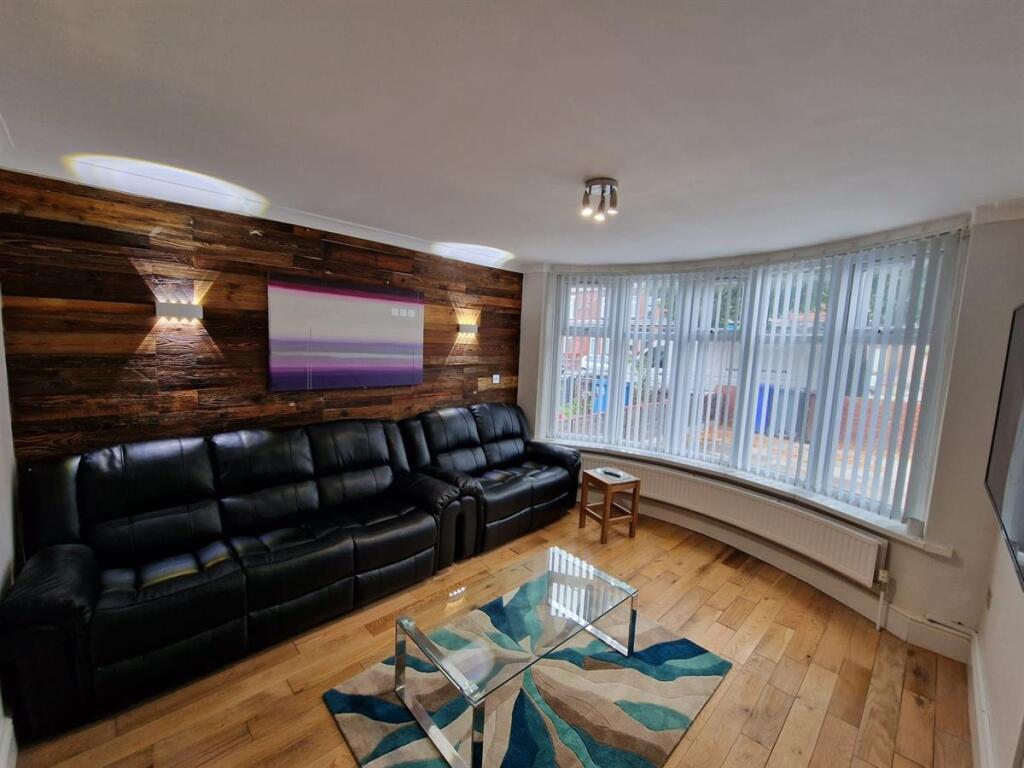 Bright contemporary living room with a large cu...