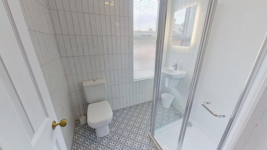 Clean and functional bathroom with a toilet, sm...
