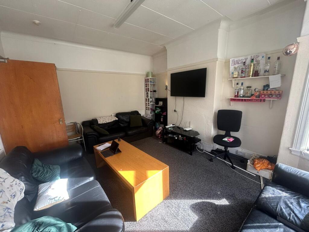 A spacious and inviting living room featuring m...