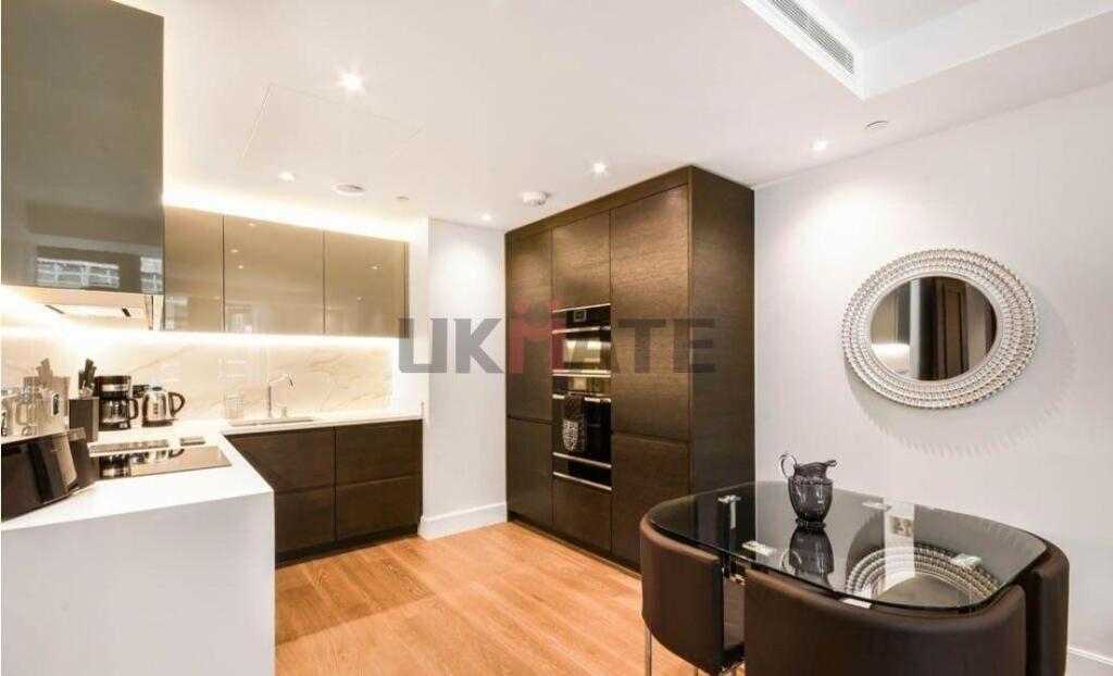 Modern and sleek kitchen with polished cabinetr...