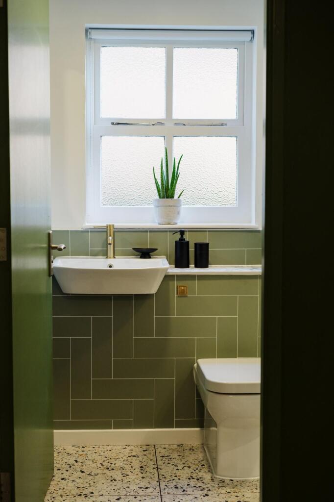Bright and stylish single toilet with modern gr...