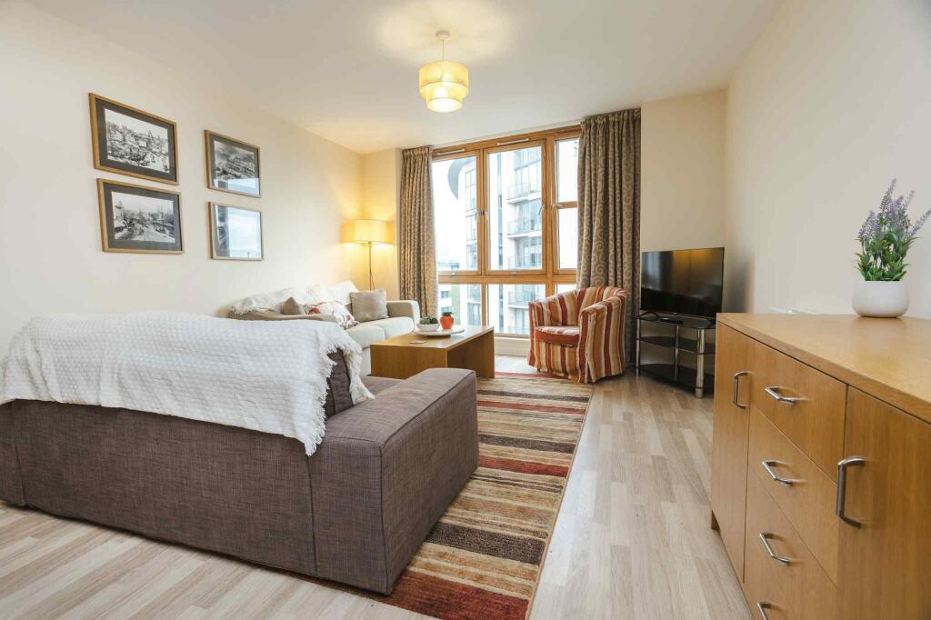 Bright and welcoming living room featuring larg...