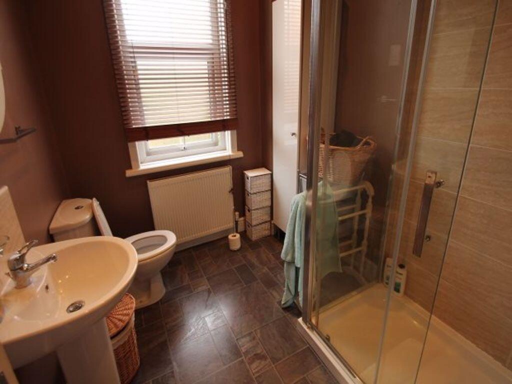 Bright and clean bathroom featuring a modern wa...