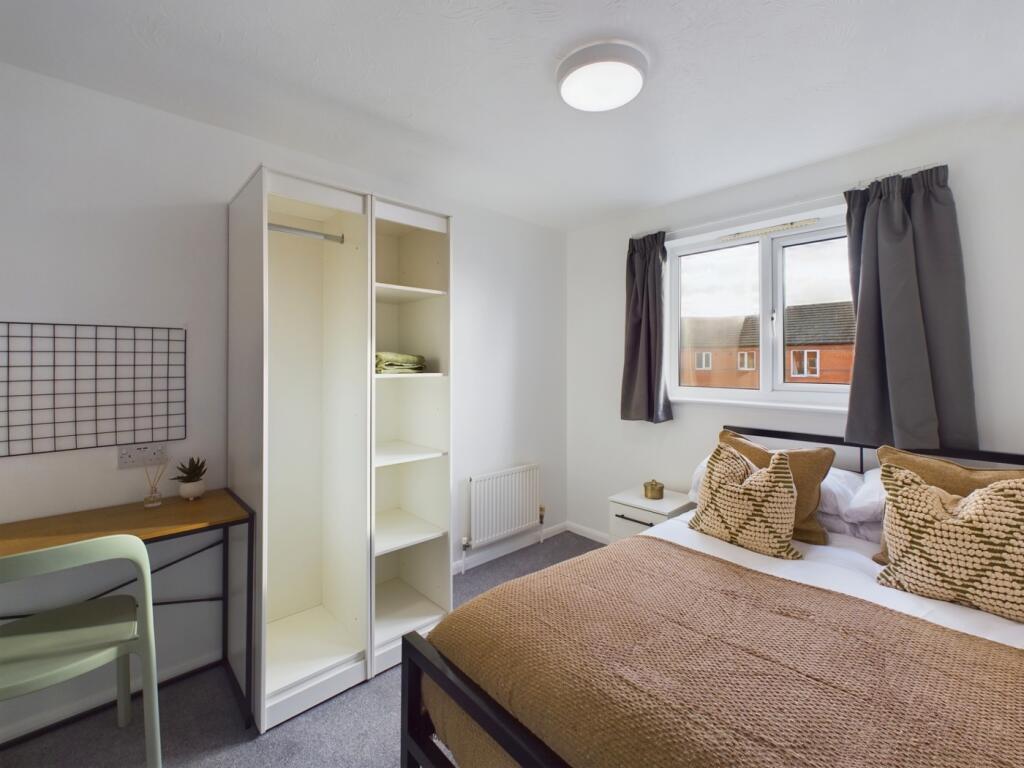 A bright and spacious double bedroom with moder...
