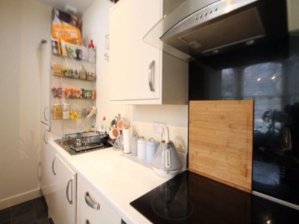 A modern, compact kitchen with a clean worktop,...