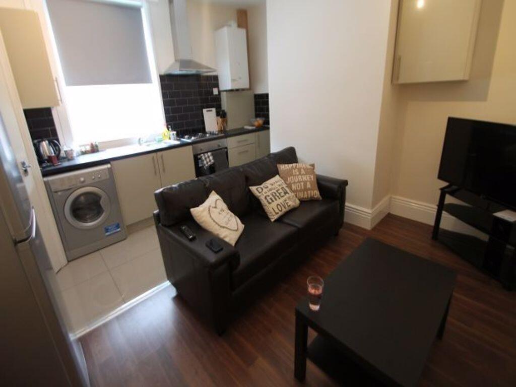 A cozy and well-maintained living room featurin...