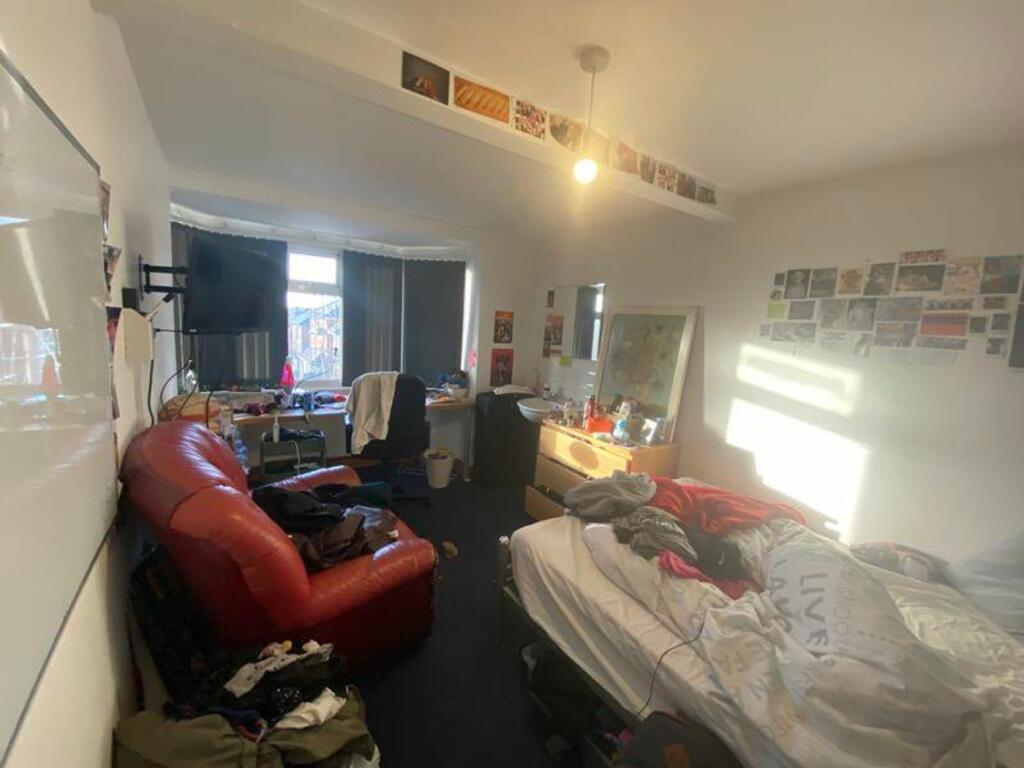 A spacious double bedroom with ample natural li...