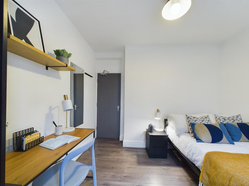 A bright and inviting double bedroom with a sty...