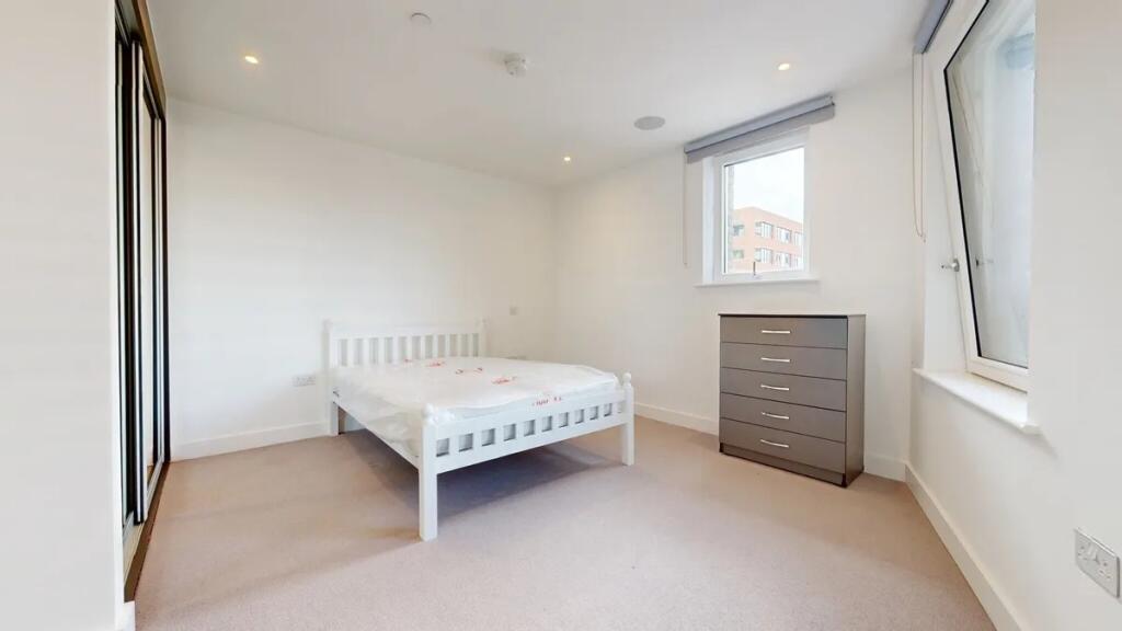 A bright and tidy double bedroom featuring a wh...