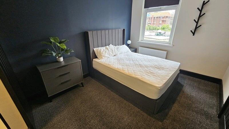 A neat and bright bedroom featuring a single be...