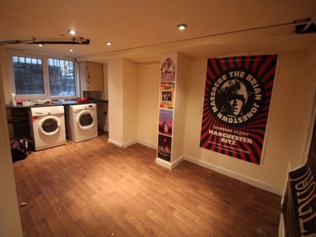 A clean, well-lit laundry room featuring two wa...