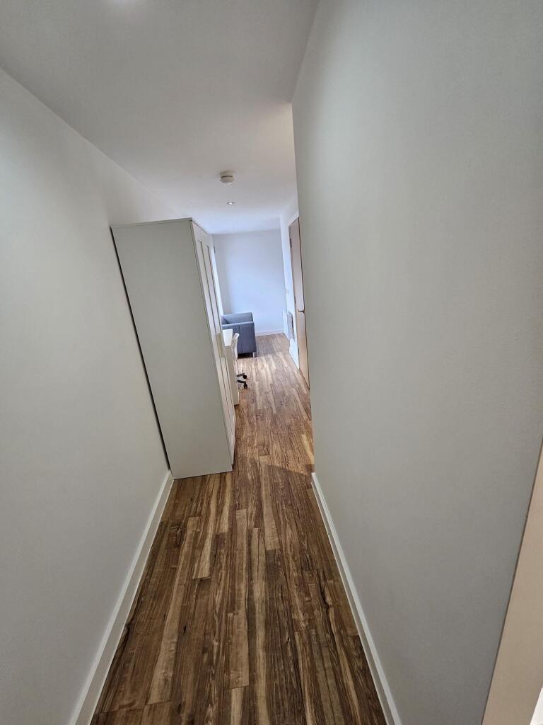 Bright and clean hallway with modern wooden flo...
