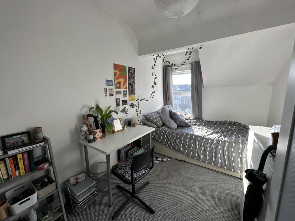 A bright and inviting double bedroom featuring ...
