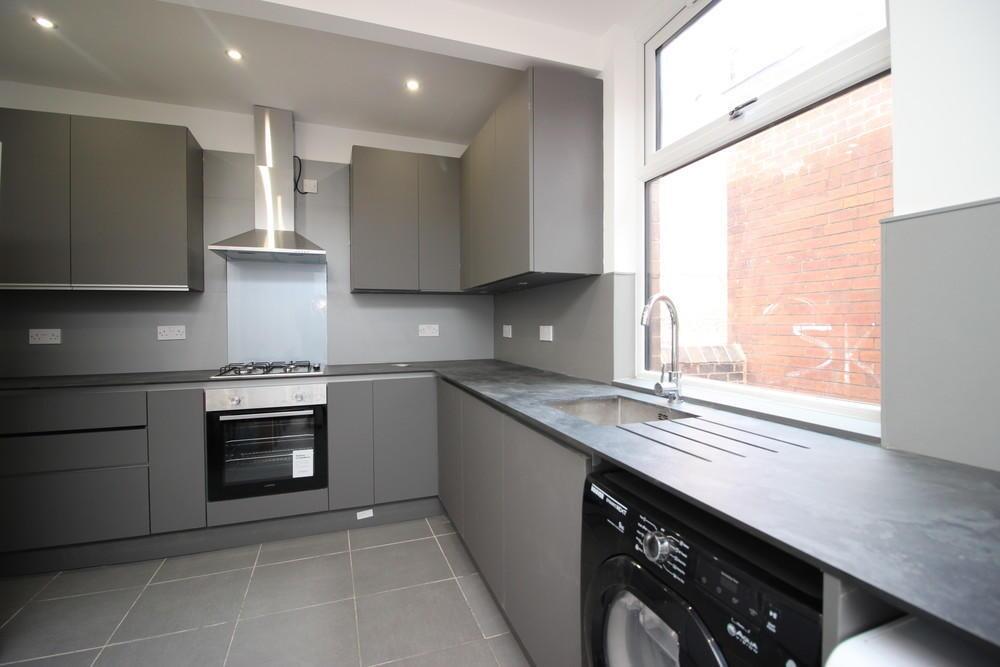 Modern kitchen with sleek grey cabinetry, integ...