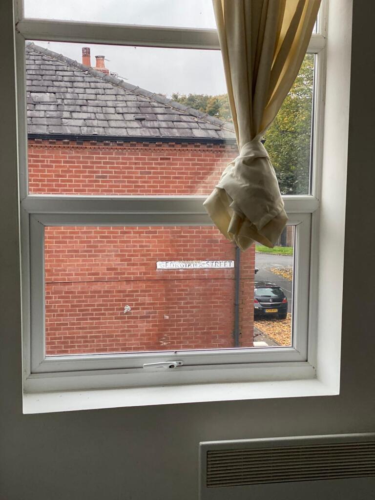 View through a clear window with a tied back cu...