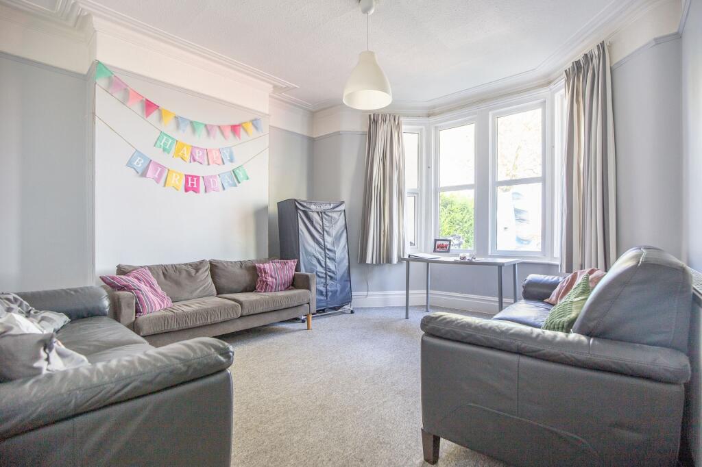 Bright and inviting living room featuring large...