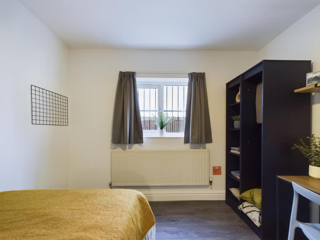 A bright and cozy double bedroom featuring a st...