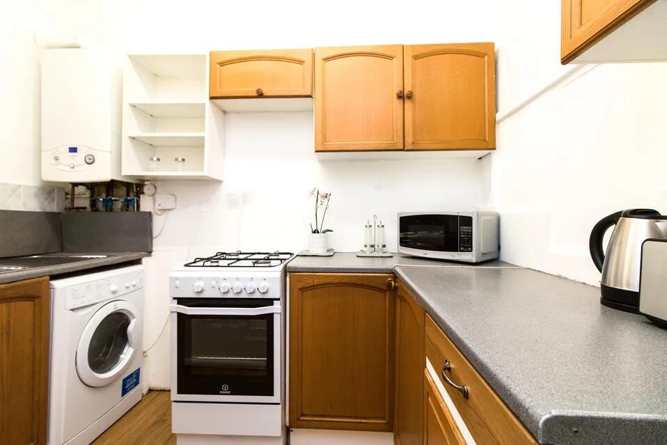 Bright and well-kept kitchen featuring ample co...