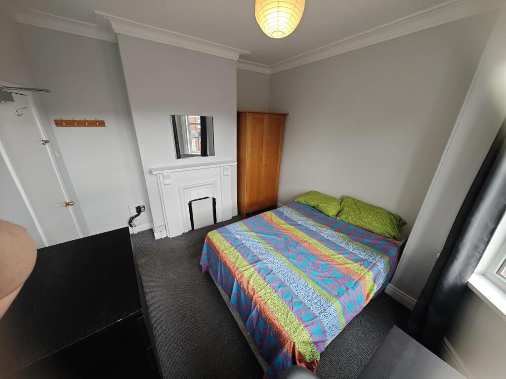 A cozy double bedroom featuring a comfortable d...