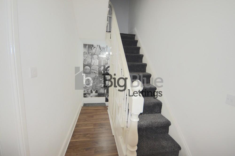 Bright and clean hallway featuring a modern sta...