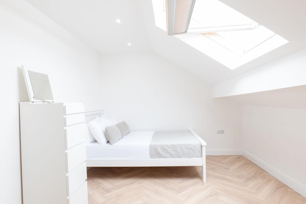Bright and airy bedroom featuring a comfortable...