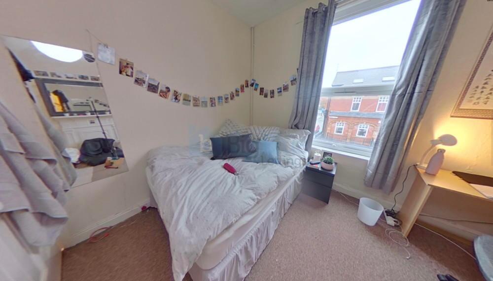 Cozy single bedroom with a comfortable bed, a s...