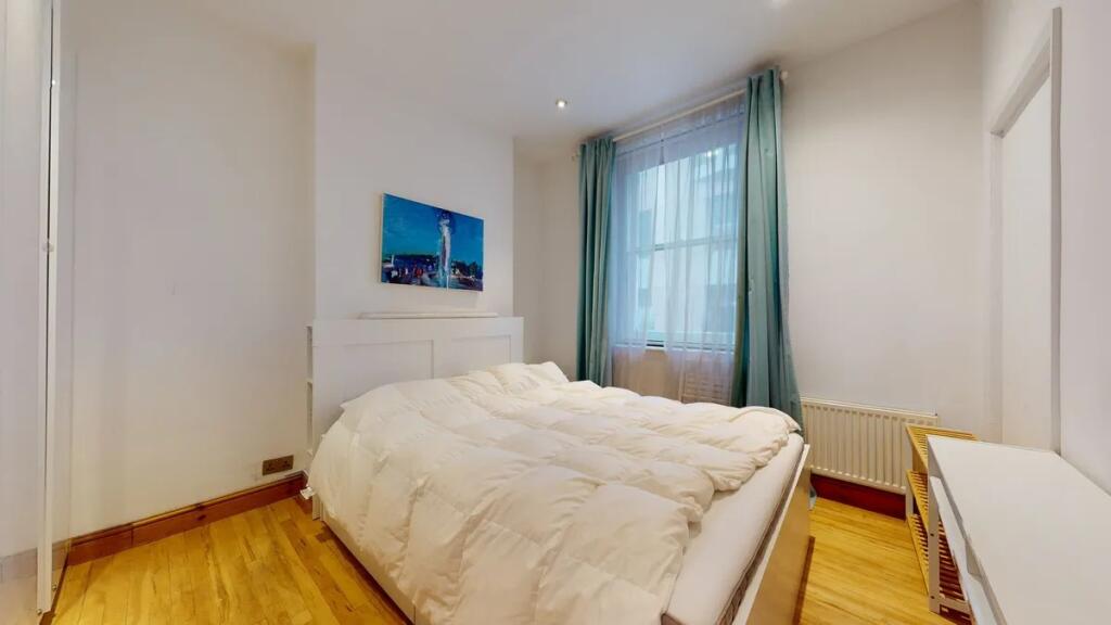 Bright and cozy double bedroom featuring a comf...