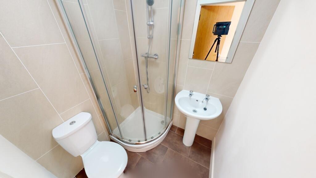 A clean and modern bathroom featuring a curved ...