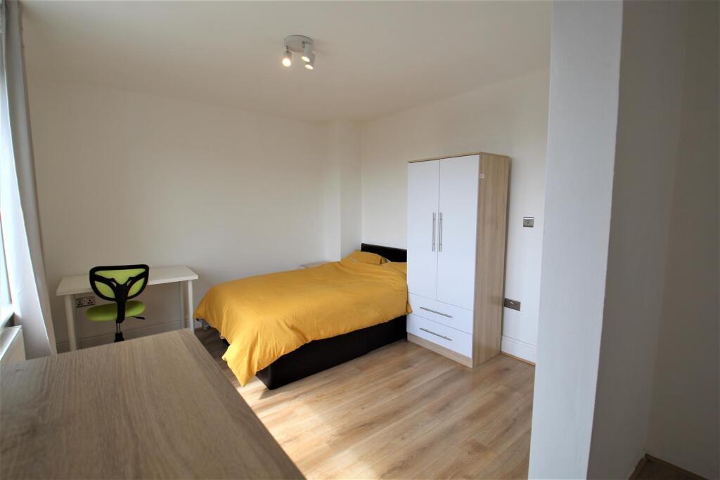 A bright and tidy double bedroom featuring a co...