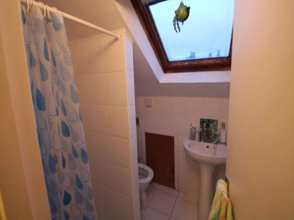 A compact and clean bathroom featuring a tiled ...