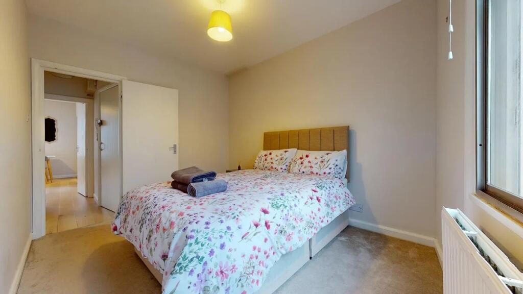 A cozy double bedroom featuring a comfortable d...