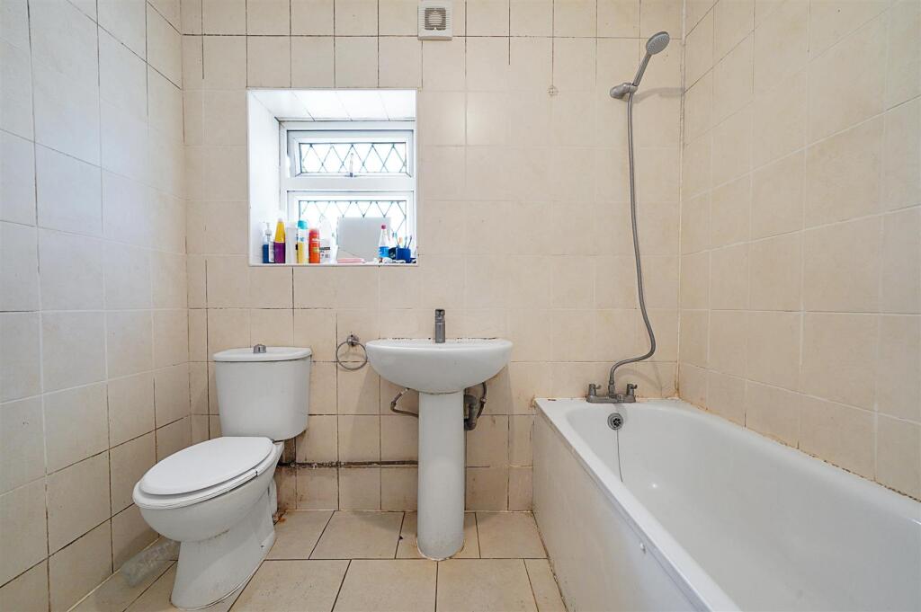 Partly tiled bathroom combined W.C