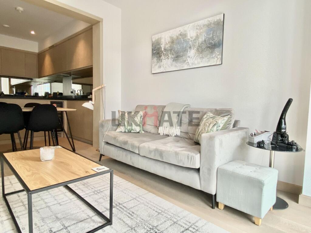 A bright and modern living room featuring a com...