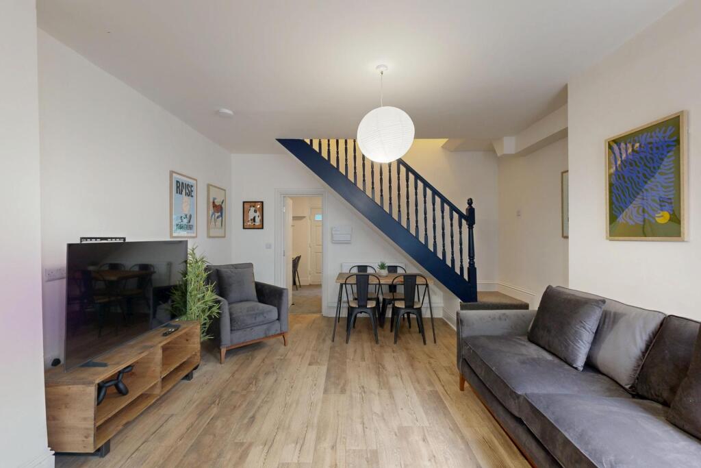 A bright and welcoming living room featuring co...