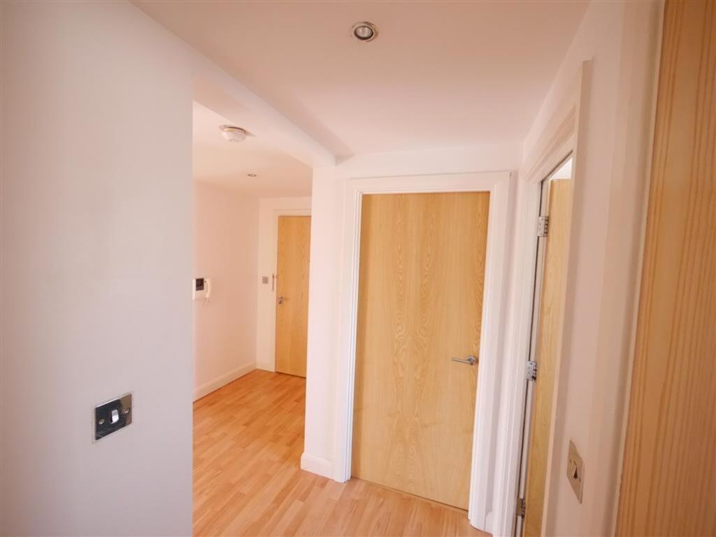 Bright and clean hallway featuring light wooden...