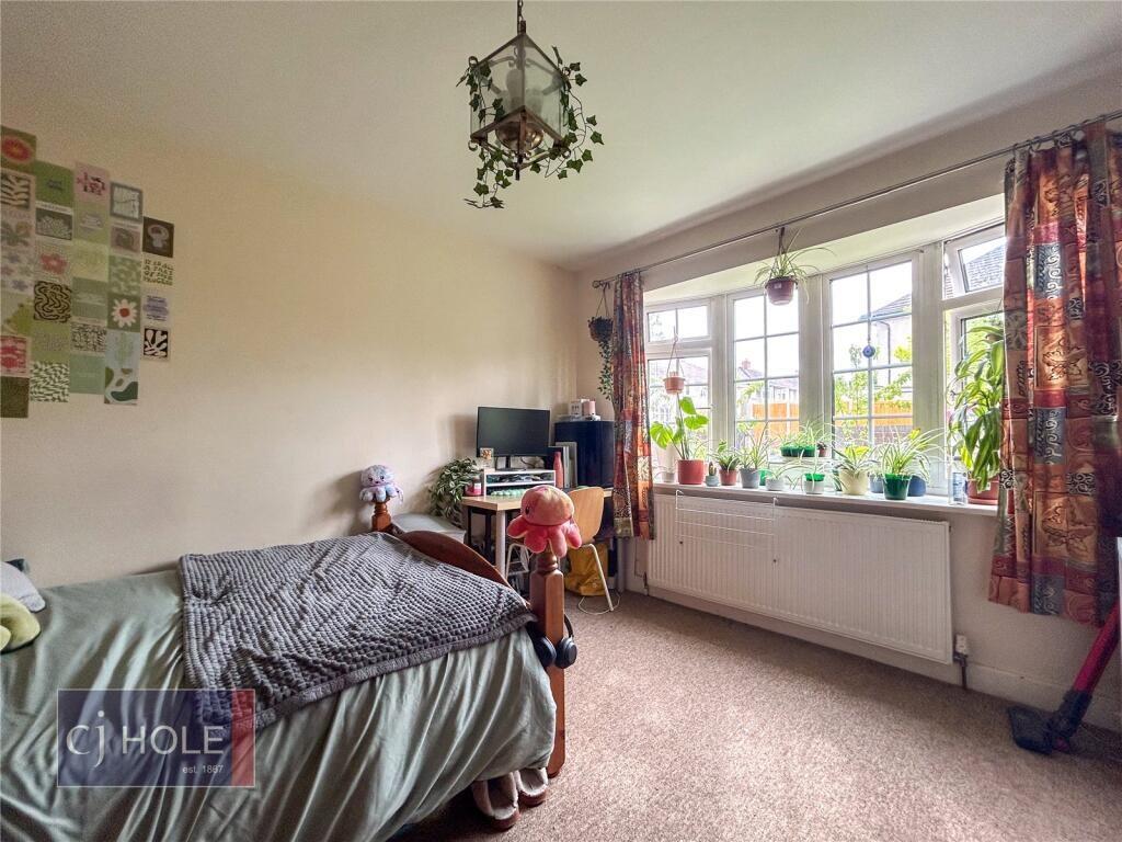 A cozy single bedroom featuring a comfortable b...