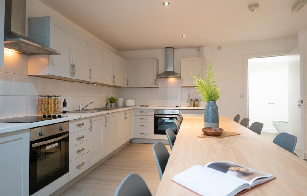 A bright and modern kitchen with ample space fo...