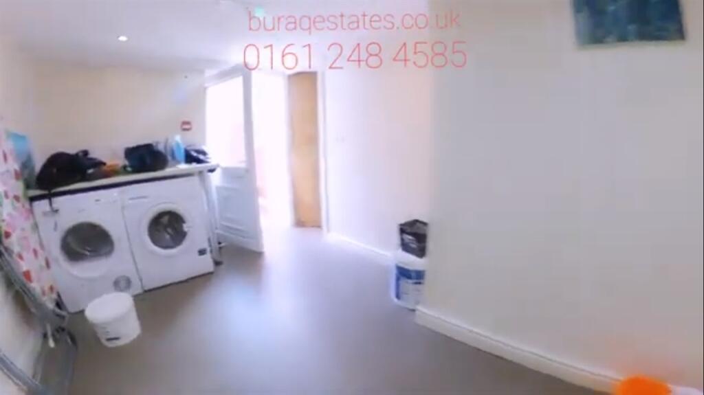 A compact, clean kitchen area featuring essenti...